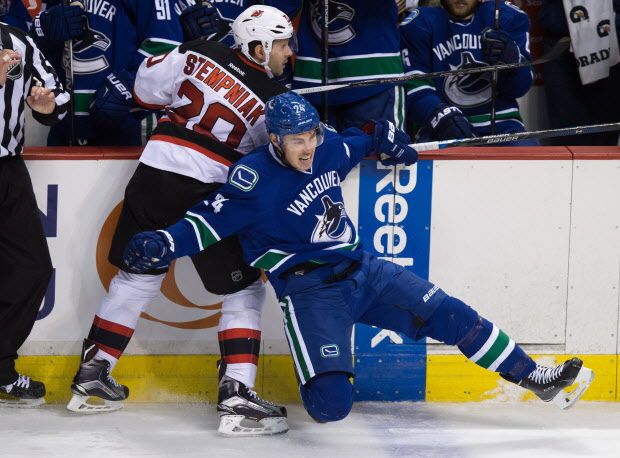 New Jersey Devils' Lee Stempniak, left, and Vancouver Canucks' Adam Cracknell collide during the third period of an NHL hockey game in Vancouver, B.C., on Sunday November 22, 2015. THE CANADIAN PRESS/Darryl Dyck