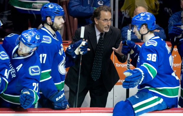 Vancouver Canucks' head coach John Tortorella, centre, gives instructions to Jannik Hansen, right, of Denmark, as Ryan Kesler listens after the Canucks scored the go-ahead goal against the Los Angeles Kings during third period NHL hockey action in Vancouver, B.C., on Saturday April 5, 2014. THE CANADIAN PRESS/Darryl Dyck ORG XMIT: VCRD130