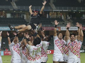 The Japan rugby team celebrates after Japan qualified for the 2016 Rio Olympics by winning the final match of Asia Rugby Sevens against Hong Kong in Hong Kong, Sunday, Nov. 8, 2015. (AP Photo/Kin Cheung)