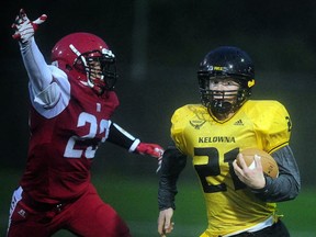 St. Thomas More's Joshua DuMont (left)  slows down Kelowna's Parker Simson on Friday at Burnaby Lakes. (PNG photo by Nick Procaylo)