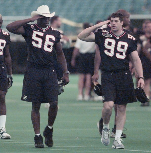 prv080900lions04 -- SEE SPORTS -- VANCOUVER, BC -- AUG 09 2000 -- The BC Lions wore hats to practise.  Daved Benefield and  Jason Kralt practise saluting as they leave the field. Province staff photo by Gerry Kahrmann [PNG Merlin Archive]