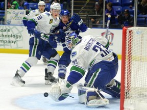 In this photo taken on Friday, Nov. 6, 2015, Utica Comets goalie Jacob Markstrom blocks a goal attempt as Comets player Brendan Gaunce and Toronto Marlies player Brendan Leipsic watch during an AHL hockey game at the Utica Memorial Auditorium, in Utica, N.Y.