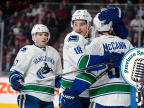 MONTREAL, QC - NOVEMBER 16:  Jared McCann #91 of the Vancouver Canucks celebrates his goal with teammate Jake Virtanen #18 during the NHL game against the Montreal Canadiens at the Bell Centre on November 16, 2015 in Montreal, Quebec, Canada. (Photo by Minas Panagiotakis/Getty Images)