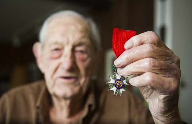 WEST VANCOUVER,BC:NOVEMBER 9, 2015 -- Lloyd Williams, a WW2 vet, poses for a photo with a recently received the Legion of Honour medal from the French government as his home in West Vancouver, BC, November, 9, 2015. (Richard Lam/PNG) (For Patrick Johnston) 00040079A