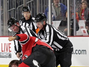 Jordin Tootoo of the New Jersey Devils fights with Derek Dorsett of the Vancouver Canucks during the second period at the Prudential Center on November 8, 2015 in Newark, New Jersey. (Photo by Adam Hunger/Getty Images)