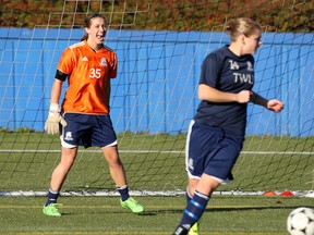 Trinity Western University goalkeeper Ally Williamson shouts encouragement to teammate Krista Gommeringer during training session Wednesday at UBC’s Thunderbird Stadium. TWU and UBC are each part of the eight-team field which opens play Thursday on the Point Grey campus at the 2015 CIS women’s soccer championships. (Photo – Scott Stewart, TWU athletics)