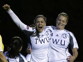 Celebrating the goal that advanced her team to this weekend’s Canada West’s Select Six conference championship tournament, Trinity Western rookie Rachel Hutchinson (centre) is congratulated by teammates Seina Kashima (left) and Krista Gommeringer (right) during the Spartans’ 1-0 quarterfinal win Friday over the Alberta Pandas in Langley. (Scott Stewart, TWU athletics)