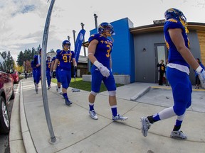 UBC players, including Kevin Wiens (3) make their traditional pre-game walk from their dressing room to the field at Thunderbird Stadium, passing in front of the school’s new, $1.1 million football academic learning centre. (Photo — Bob Frid, UBC athletics)