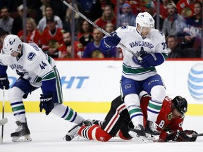 Even sitting on opponents didn't bring the Canucks any luck on Sunday in Chicago. (AP Photo/Andrew A. Nelles)