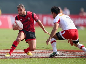 Luke Treharne of Wales evades a tackle by Phillip Mack of Canada during the Emirates Dubai Rugby Sevens - HSBC World Rugby Sevens Series at The Sevens Stadium  on December 5, 2015 in Dubai, United Arab Emirates.  (Photo by Francois Nel/Getty Images)