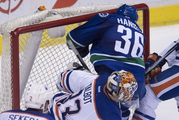 Vancouver Canucks right wing Jannik Hansen (36) crashes into the crossbar of the net as he tries to get a shot past Edmonton Oilers goalie Cam Talbot (33) during third period NHL action Vancouver, B.C. Saturday, Dec. 26, 2015. THE CANADIAN PRESS/Jonathan Hayward