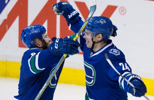 Vancouver Canucks' Adam Cracknell, right, and Brandon Prust celebrate Prust's goal against the Buffalo Sabres during the second period of an NHL hockey game in Vancouver, B.C., on Monday December 7, 2015. THE CANADIAN PRESS/Darryl Dyck