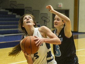Kendal Sands (left) of Coquitlam's Dr. Charles Best Blue Devils drive past North Vancouver-Seycove Seahawks' guard Marley Beckett on Thursday at the LEC. (Steve Bosch, PNG)
