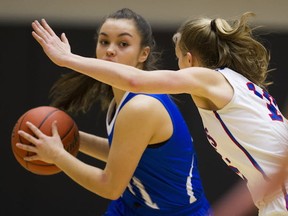 R.A. McMath's Lyric Custodio (left) looks to pass against Brookswood's Julia Marshall on Saturday at the TBI Final in Langley. (Gerry Kahrmann, PNG)