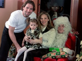 Canucks player Ed Jovanovski, his wife Kirstin and daughter Kylie with Santa Claus at the 2001 Canucks team Christmas party.  (Photo:  Jeff Vinnick/Vancouver Canucks)