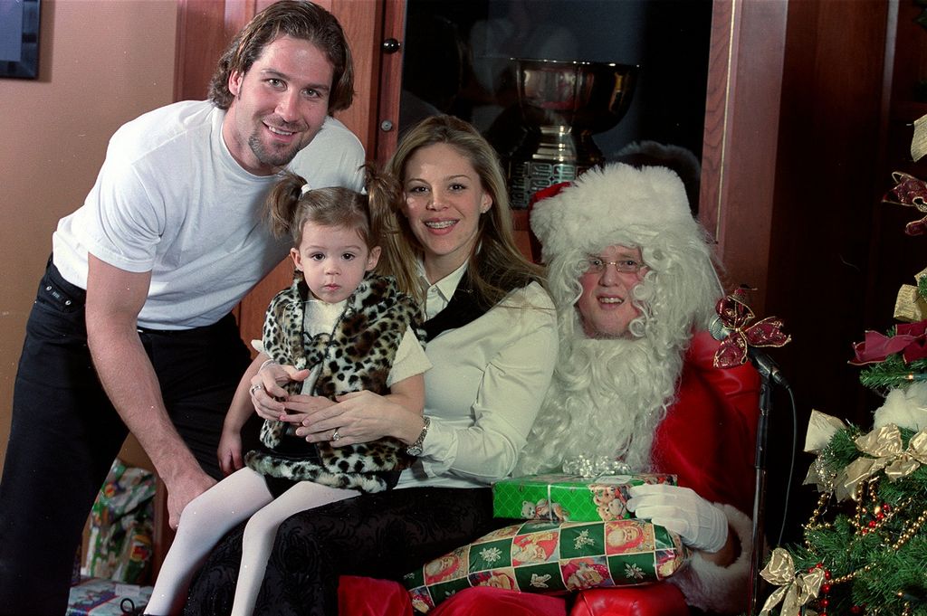 Vancouver, Jan. 30, 2001 - Canucks player Ed Jovanovski, his wife Kirstin and daughter Kylie with Santa Claus (who looks like a close relative of the Sedin twins).  (Photo:  Jeff Vinnick/Vancouver Canucks) [PNG Merlin Archive]