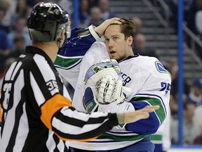 Canucks goalie Jacob Markstrom complains to a referee about being hit after the whistle last night in Tampa. Markstrom was not penalized on the play.