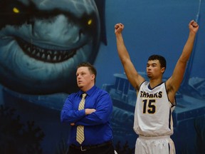 Steveston-London Sharks head senior boys basketball coach Mike Stoneburgh and his star player, senior guard Neil Boyd, pictured in front of the large shark mural in the school’s gymnasium, watch a late basket being scored as part of the team’s 97-79 victory Tuesday over its crosstown rivals, the R.C. Palmer Griffins. (Howard Tsumura, PNG photo).