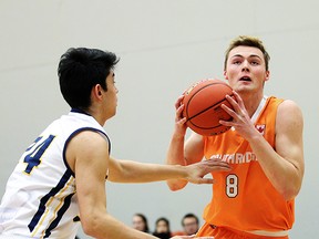 Storm forward Hunter Hughes looks to put up a shot against Sharks defender Pierce Strutt at the Tsumura Basketball Invitational tournament at Langley Events Centre, Langley BC, December 10 2015. Photo: Ron Hole