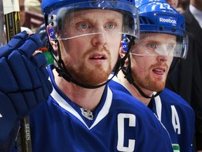 Henrik and Daniel Sedin can't keep carrying the Canucks on their shoulders. (Getty Images via National Hockey League).