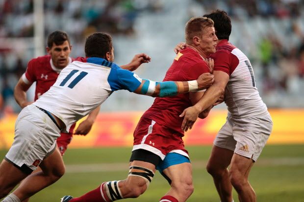 Canada's John Moonlight (C) is tackled by France's Sacha Valleau (L) and Vincent Inigo (R) during the second round of the World Series Sevens rugby match at the Cape Town stadium in Cape Town on December 12, 2015. / AFP / GIANLUIGI GUERCIAGIANLUIGI GUERCIA/AFP/Getty Images