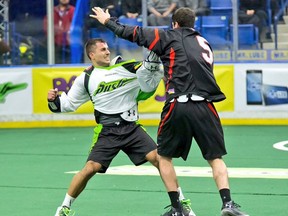 Nik Bilic of the Rush and Cliff Smith of the Stealth exchange pleasantries in Vancouver's 13-11 win Friday in Saskatoon. (NLL photo.)