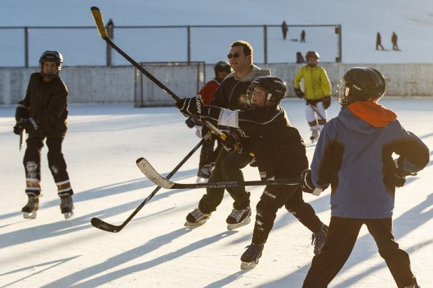 Members of the North Seera PeeWee Benders play a hockey game on New Year's Eve on the outdoor rink at Cloverdale Community League in Edmonton, Alta., on Thursday December 31, 2015. Ian Kucerak/Edmonton Sun/Postmedia Network