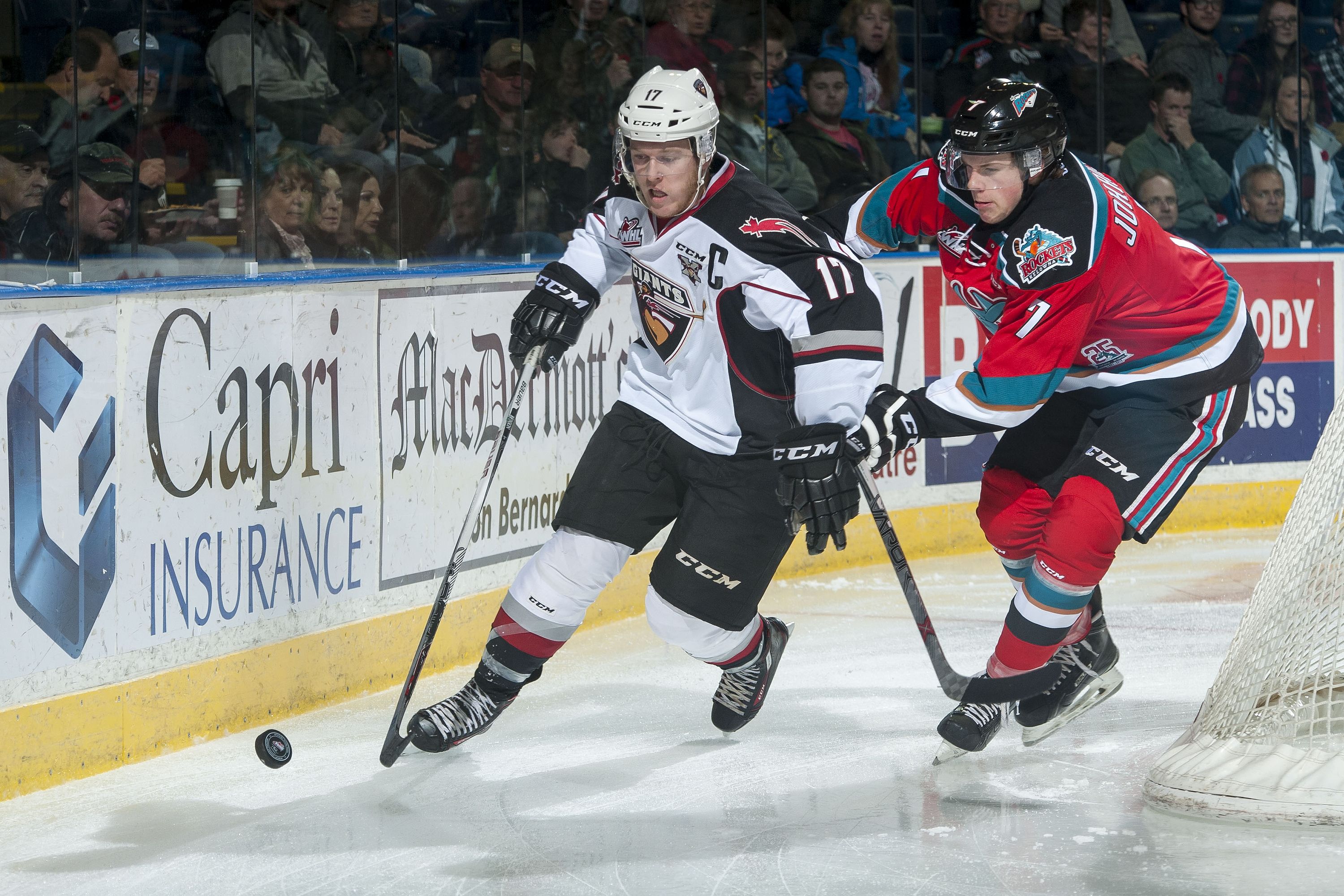 KELOWNA, CANADA - NOVEMBER 11: Lucas Johansen #7 of Kelowna Rockets checks Tyler Benson #17 of Vancouver Giants as he skates behind the net with the puck during first period on November 11, 2015 at Prospera Place in Kelowna, British Columbia, Canada. (Photo by Marissa Baecker/Getty Images)