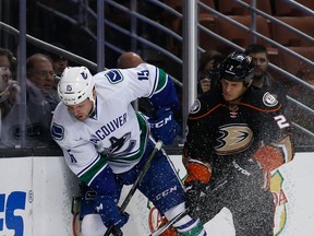 Derek Dorsett of the Vancouver Canucks crashes into Kevin Bieksa of the Anaheim Ducks during the second period of a game at Honda Center on November 30, 2015 in Anaheim, California.  (Photo by Sean M. Haffey/Getty Images)