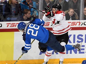 Canada's Jake Virtanen (18) tries to knock Finland's Juho Lammikko off the puck during the quarterfinal of the IIHF World Junior Championship, in Helsinki, Finland, on Saturday. He took three penalties in the game, including two crucial ones in the third that led to Finland's game winner.