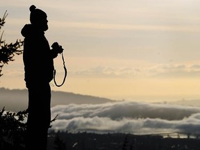 Tourists and locals alike love to take photos of the city. Here are Tourism Vancouver's top 10 locations. (Pictured: A photographer views a temperature inversion fog over Vancouver from Cypress Mountain.)