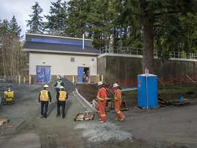 Workers outside the water reservoir in White Rock.