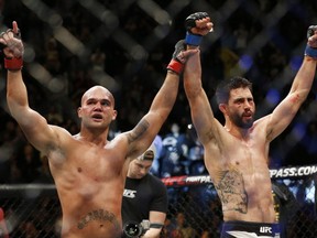 Robbie Lawler, left, and Carlos Condit celebrate after their welterweight championship bout.