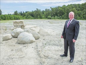 Coun. Bruce Hayne stands on land in North Surrey back in June where a sports facility has been proposed. (Province Files.)