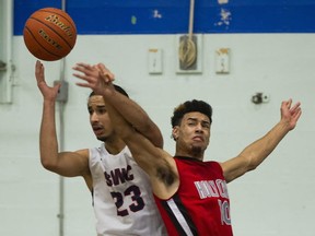 Winston Churchill's Karn Virk (left) battles Nic Best of Holy Cross on Friday during Bulldogs Classic championship final in Vancouver. (Gerry Kahrmann, PNG)