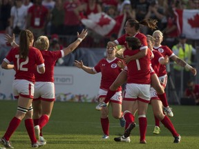 Canadian players celebrate at the final whistle as they win the gold medal in women's rugby sevens after beating the USA 55-7 in the final at the 2015 Pan Am games in Toronto on Sunday, July 12, 2015. THE CANADIAN PRESS/Chris Young