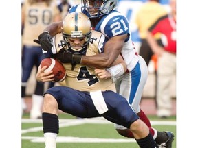 MIke Edem, getting after Winnipeg quarterback Buck Pierce in 2013 while with Montreal, signed with the B.C. Lions as a free agent Tuesday afternoon. (Canadian Press files.)