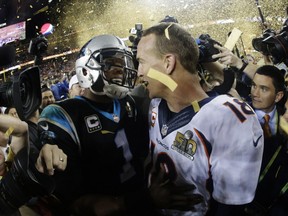 Denver Broncos Peyton Manning, right, greets Carolina Panthers Cam Newton (1) after the NFL Super Bowl 50 football game Sunday, Feb. 7, 2016, in Santa Clara, Calif. The Broncos won 24-10. (AP Photo/Julio Cortez)