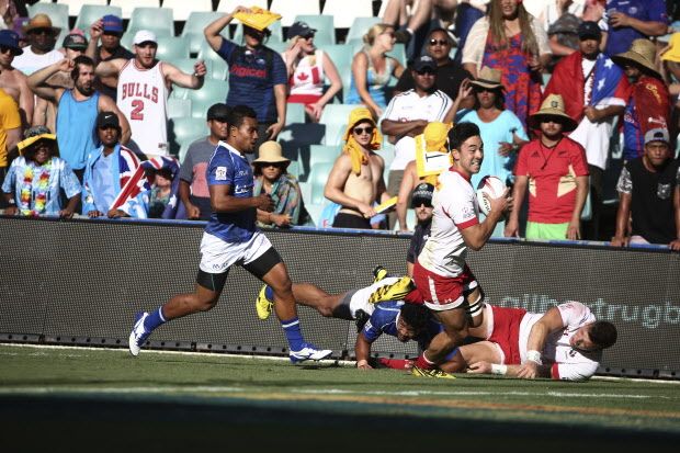 Nathan Hirayama, right, of Canada takes the ball as he runs in to score a try during the World Rugby Sevens Series bowl final against Samoain Sydney, Australia, Sunday, Feb. 7, 2016. (AP Photo/Rob Griffith)