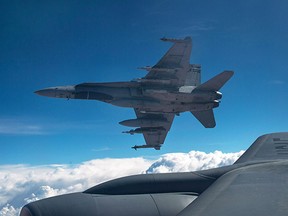 A Royal Canadian Air Force CF-18 Hornet breaks away after refueling with a KC-135 Stratotanker over Iraq.