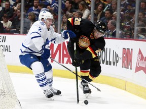 Emerson Etem, battling here with Matt Hunwick of the Maple Leafs, gets back in the line-up for the Canucks tonight against Anaheim.  (Photo by Jeff Vinnick/NHLI via Getty Images)