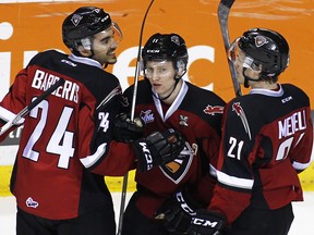 Chase Lang (centre) got lots of practice with his goal celebration on Friday. It didn't lead to a victory for the Vancouver Giants, though. (Getty Images File.)