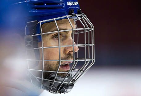 Recognize that face? Dan Hamhuis, behind a cage at Canucks practice last week, hopes to return to the lineup with a rebuilt jaw on Thursday. (Darryl Dyck, CP files)