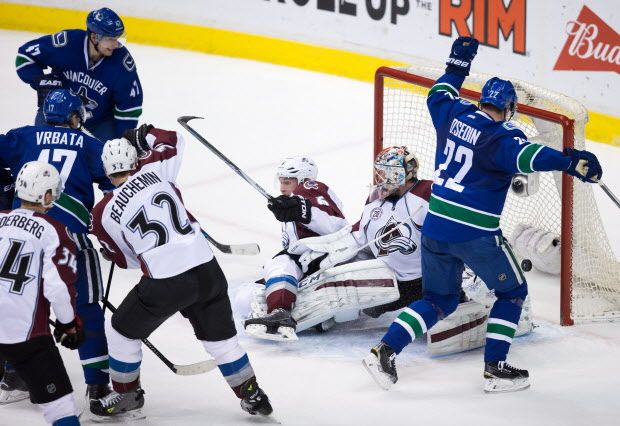 Vancouver Canucks' Radim Vrbata (17), of the Czech Republic, scores against Colorado Avalanche goalie Semyon Varlamov, second right, of Russia, as Carl Soderberg (34), of Sweden, Francois Beauchemin (32) and Erik Johnson, centre, and Canucks' Sven Baertschi, top left, of Switzerland, and Daniel Sedin, right, of Sweden, look on during the second period of an NHL hockey game in Vancouver, B.C., on Sunday February 21, 2016. THE CANADIAN PRESS/Darryl Dyck