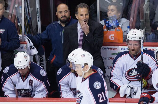 Columbus Blue Jackets coach John Tortorella, top centre, stands on the bench during the second period of an NHL hockey game against the Vancouver Canucks in Vancouver, B.C., on Thursday February 4, 2016. THE CANADIAN PRESS/Darryl Dyck
