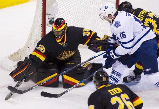 Vancouver Canucks goaltender Ryan Miller (30) makes a save against Toronto Maple Leafs' Nick Spaling (16) during second period NHL hockey action in Vancouver, B.C., on Saturday February 13, 2016. THE CANADIAN PRESS/Ben Nelms