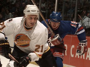 Jyrki Lumme looking sharp in the Canucks' flying-skate jersey in a December 1995 game, the team's first season at Rogers Arena. You could have this look too! (Rick Loughran, PNG files)