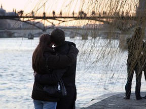 A couple kisses on Valentine's Day, 2009, near the river Seine in Paris.