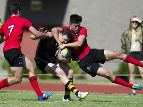 Mostyn Findlay is tackled by Saint George's Greg Atkinson in the 2015 BC High school Rugby AAA final at Rotary Stadium, Abbotsford. (Gerry Kahrmann/PNG)