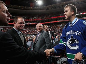 Russian prospect Nikita Tryamkin meets with members of the Canucks staff after being drafted in 2014. A News 1130 report says he may finish the season in Utica.
